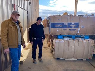 CARDBOARD Lorenzo Edward by the carboard bales awaiting pickup